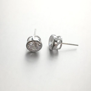 Close-up of 925 silver stud earrings with round-cut clear cubic zirconia bezel setting