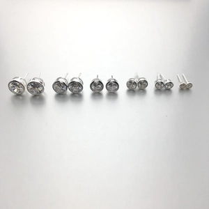 Detail view of round 925 silver stud earrings with clear zircon stones in various sizes
