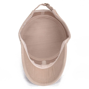 Adjustable beige flat top cap showing interior fabric texture and metal buckle