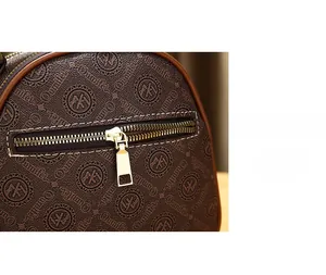 Close-up of brown printed leather mini bag featuring a back anti-theft zipper pocket