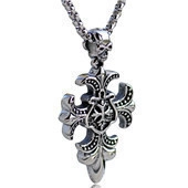 Detailed close-up of silver steel cross pendant featuring an intricate skull design
