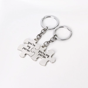 Macro shot of silver metal interlocking puzzle keychains engraved with you are my person
