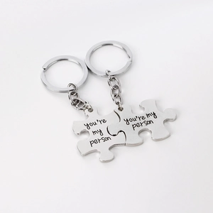 Silver puzzle piece keychains for couples with You Are My Person engraved lettering