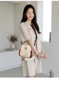 Detailed close-up of beige monogram canvas crossbody bag with elegant brown leather trim