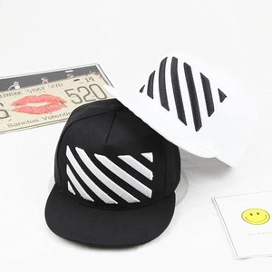 Detail of street style flat brim caps with diagonal stripe embroidery in black and white