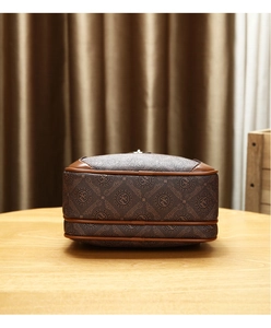 Detailed side view of brown PU leather crossbody bag with logo pattern and layered base