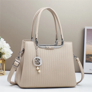 Chic beige crossbody handbag with vertical geometric embossing and pearl star charm
