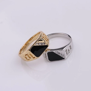 Detailed close-up of geometric enamel rings with diagonal rhinestone accents and carved sides