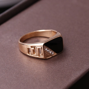 Macro shot of gold-plated ring featuring black enamel inlay and zircon side accents