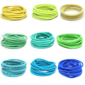 Detail view showing nine colorful 3mm high elasticity seamless hair ties for children