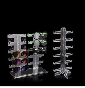 Clear acrylic multi-tier glasses display stand showcasing sunglasses on black background