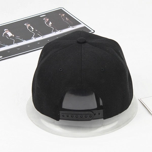 Rear view of a black flat-brim snapback hat with adjustable buckle and cotton fabric