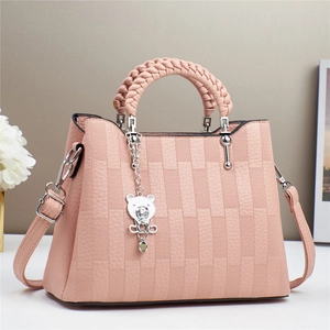 Elegant pink embossed leather handbag with woven handle and bear charm for women