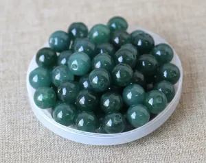 Close-up of polished dark green natural jade beads with center holes for DIY jewelry