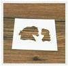 Macro detail of white plastic coffee stencil featuring a profile silhouette on wood surface