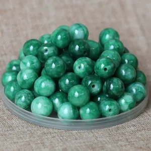 Close-up of green natural jade round beads for DIY jewelry and traditional clothing
