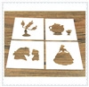 Detail of four white hollow paper templates featuring Beauty and the Beast patterns on wood