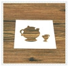 Detail of white plastic stencil with cutout teapot and teacup patterns on wood background