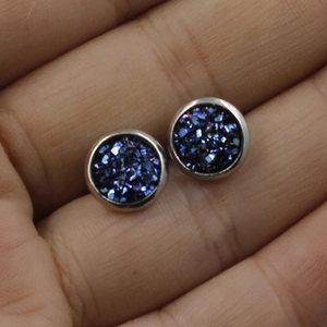 Macro shot of dark blue stardust crystal earrings with 8mm stainless steel base