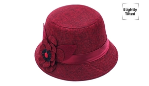 Detailed side view of a wine red cloche hat featuring large 3D flowers and satin ribbon