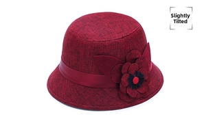 Detail of wine red linen sun hat featuring a large 3D flower and satin ribbon decoration