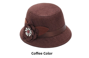 Detail of coffee linen sun hat featuring an elegant three-layer floral ornament with leather band