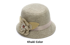 Close-up of khaki linen sun hat with floral decoration and woven texture details