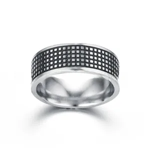Macro view of vintage titanium steel ring with black checkered pattern and geometric design