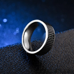 Macro shot of titanium steel ring with black and white checkered enamel details