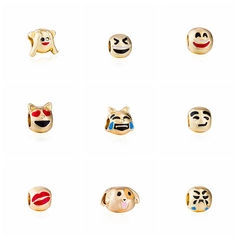 Macro detail of nine gold-plated emoji charms for DIY snake chain bracelet making