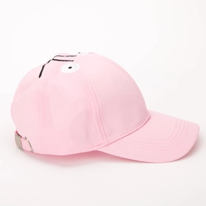 Detail of pink canvas baseball cap with embroidered cartoon face and silver buckle