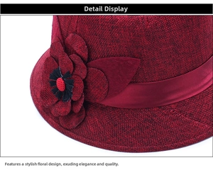 Macro detail of wine red linen sun hat featuring decorative fabric flowers and ribbon