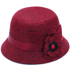 Deep red linen sun hat for women featuring a large floral accent and silk ribbon decoration