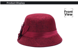 Front view of a burgundy linen cloche hat with a satin ribbon and decorative fabric flower