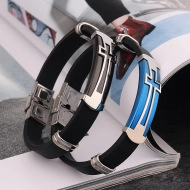 Detailed view of black silicone bracelets with silver and blue cross steel charms