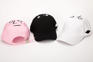 Close-up of face embroidery and metal adjustable buckle on cotton baseball caps