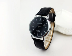 Close-up of classic black leather strap watch with Roman numerals and silver case