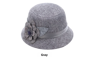 Detail of gray linen sun hat featuring a decorative 3D flower and silk ribbon trim