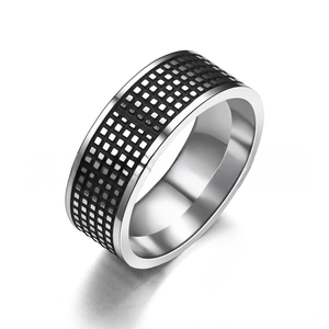 Macro detail of industrial style titanium steel ring with black checkered grid patterns