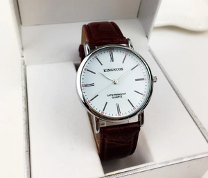 Macro detail of men's quartz watch with brown leather strap and 3ATM waterproof dial
