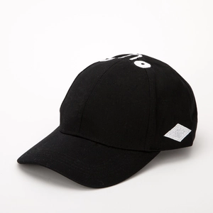 Detail of black baseball cap showing side diamond patch and quality cotton twill texture