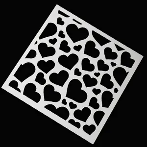 White plastic heart stencil for coffee latte art and DIY baking decoration on black background