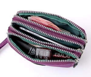Detailed view of purple nylon triple zipper pouch showing internal storage capacity