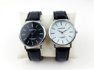 Detail of leather strap quartz watches with Roman numeral dials and silver metal case