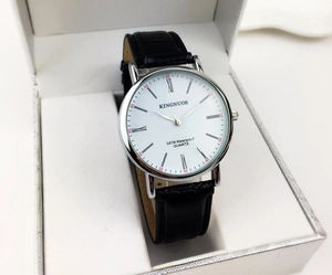 Detailed macro view of white dial with Roman numerals and black croc-leather strap watch