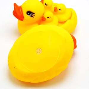 Detail of yellow rubber bath ducks showing the built-in squeaker hole on the bottom