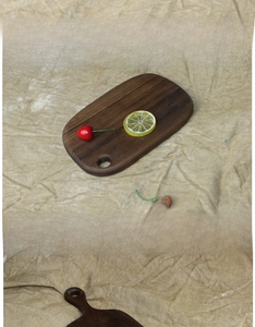 Macro shot of dark walnut bread board featuring natural wood grain and hanging hole