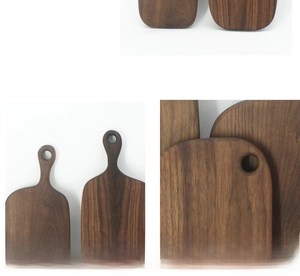 Detailed texture of black walnut wood cutting board with smooth edges and hanging handle