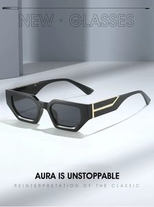 Close-up of black geometric sunglasses with golden T-shape metal inlay detail