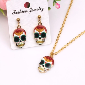Detailed view of colorful sugar skull necklace and earrings set with gold chain